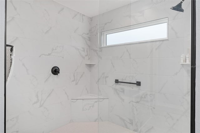 full bathroom featuring tiled shower