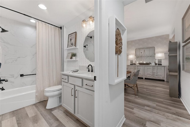 bathroom with shower / tub combo with curtain, toilet, vanity, wood finished floors, and wallpapered walls