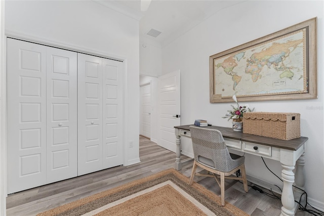 office area with baseboards and wood finished floors