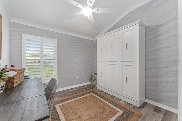 home office featuring vaulted ceiling, baseboards, wood finished floors, and wallpapered walls