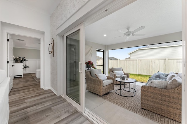 sunroom with visible vents and ceiling fan