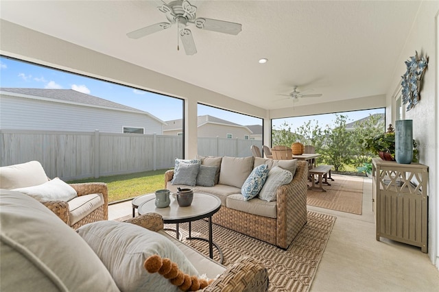 sunroom / solarium with a ceiling fan