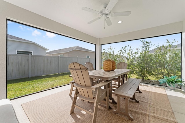 sunroom / solarium featuring a ceiling fan