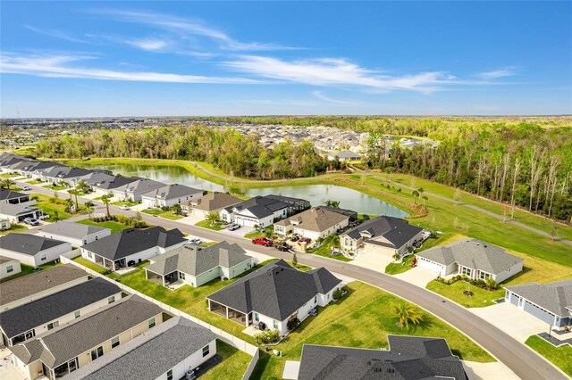 drone / aerial view with a water view and a residential view