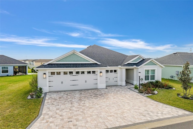 ranch-style home with a garage, decorative driveway, and a front yard