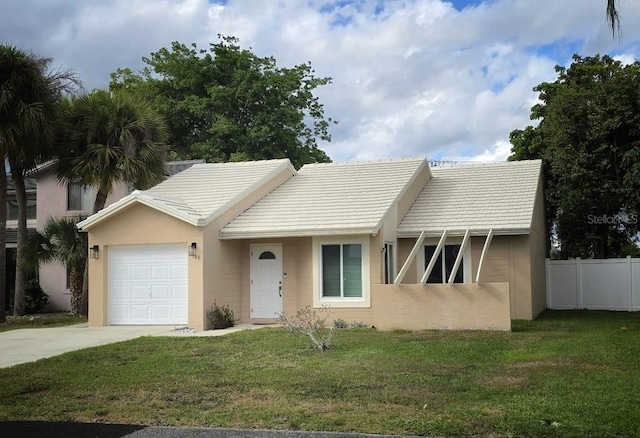 view of front facade featuring a garage, concrete driveway, fence, a front yard, and stucco siding