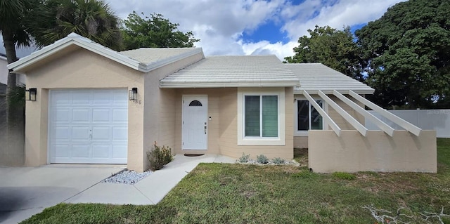 single story home featuring concrete driveway, an attached garage, fence, a front lawn, and stucco siding