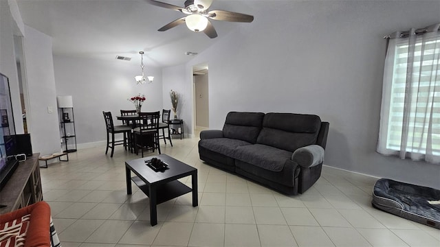 living room with lofted ceiling, visible vents, baseboards, and light tile patterned flooring