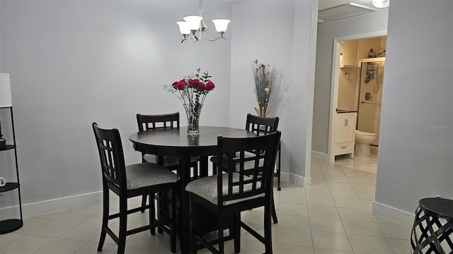 dining room featuring light tile patterned flooring and baseboards