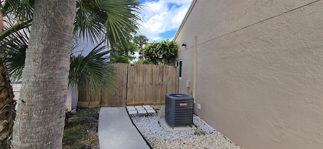 view of yard with fence and central air condition unit