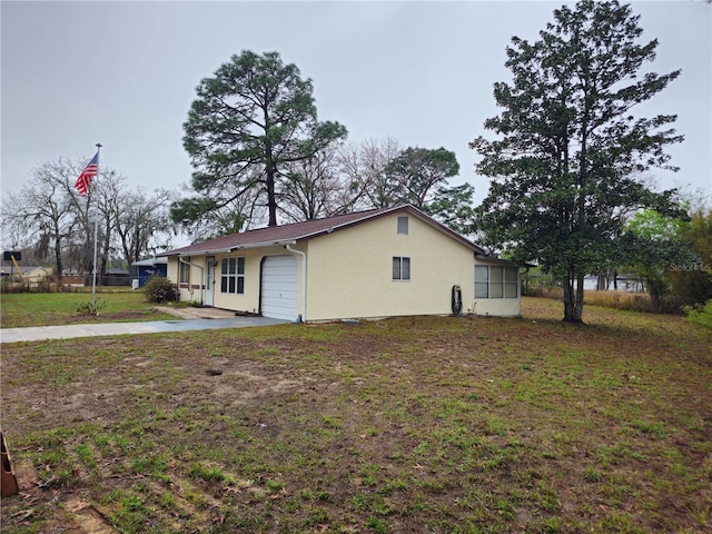 view of home's exterior featuring a yard, an attached garage, and stucco siding