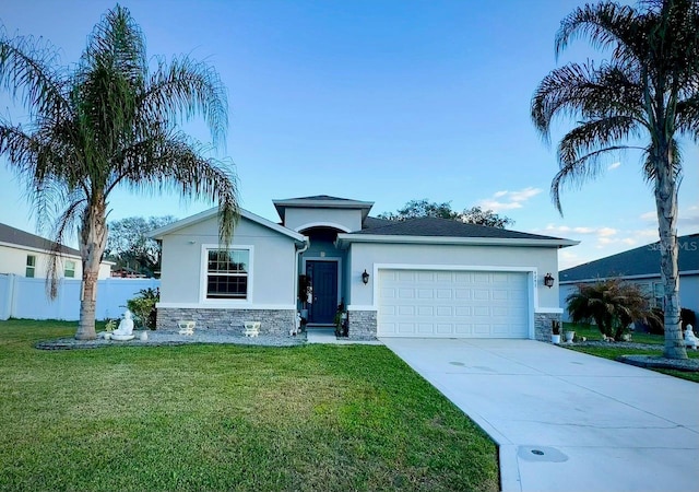 ranch-style home featuring a garage, stone siding, a front lawn, and stucco siding