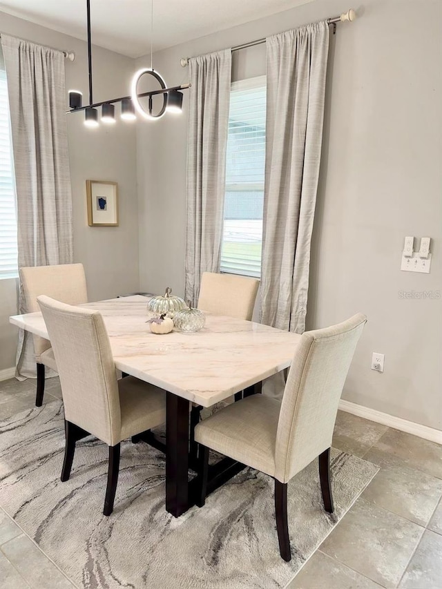 dining space featuring baseboards