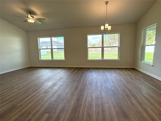 unfurnished room with baseboards, vaulted ceiling, and dark wood-style flooring