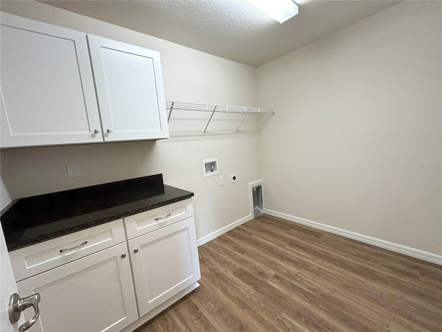 laundry room featuring washer hookup, wood finished floors, baseboards, cabinet space, and electric dryer hookup