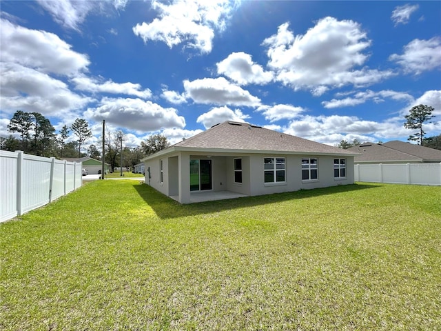 back of house featuring stucco siding, a fenced backyard, a patio area, and a yard