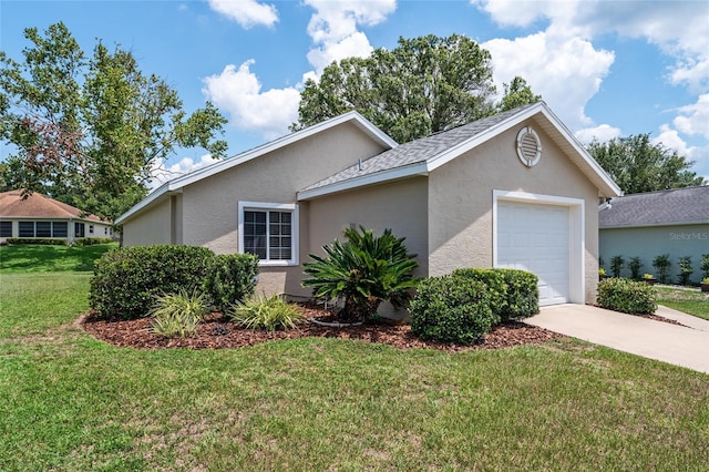 view of front of property featuring concrete driveway, a front lawn, an attached garage, and stucco siding