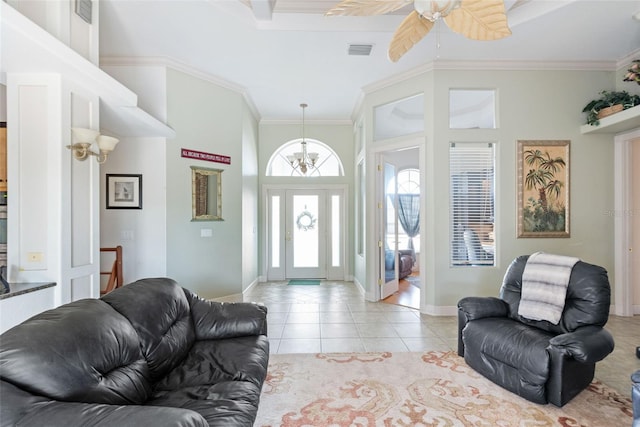 living area featuring baseboards, visible vents, ceiling fan, crown molding, and light tile patterned floors
