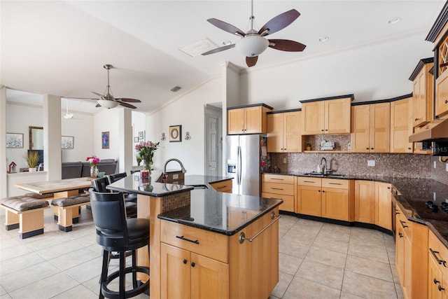 kitchen featuring stainless steel fridge, a ceiling fan, a sink, and light tile patterned floors
