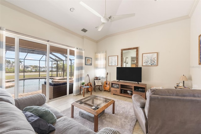 living room featuring ornamental molding, a ceiling fan, visible vents, and light tile patterned floors