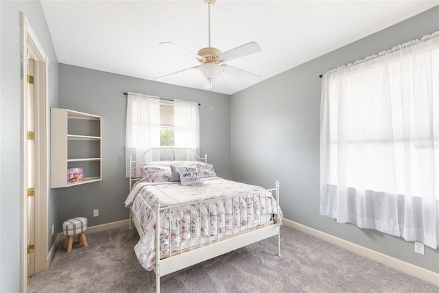 carpeted bedroom featuring a ceiling fan and baseboards