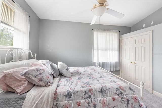 bedroom with baseboards, carpet flooring, a closet, and ceiling fan