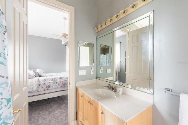 full bath with ensuite bath, vanity, and ceiling fan