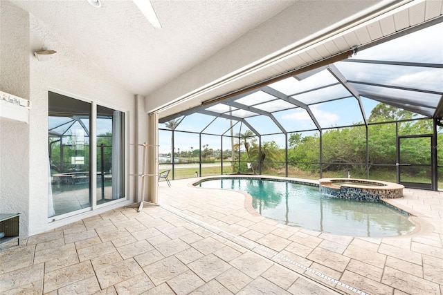 view of pool with a lanai, a pool with connected hot tub, and a patio