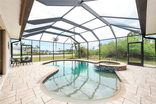 view of swimming pool featuring glass enclosure, a patio area, and a pool with connected hot tub