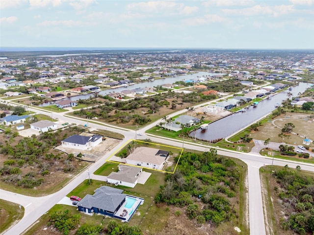 birds eye view of property with a residential view and a water view