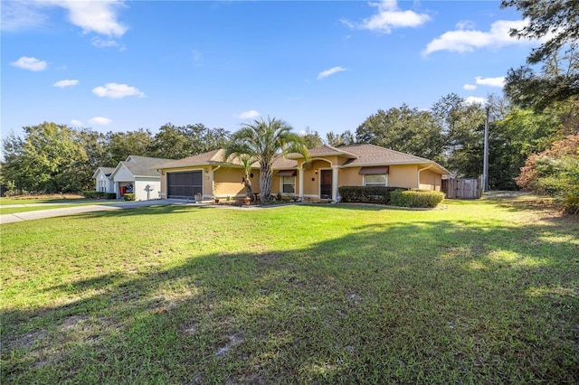 ranch-style house with a garage, fence, concrete driveway, stucco siding, and a front yard