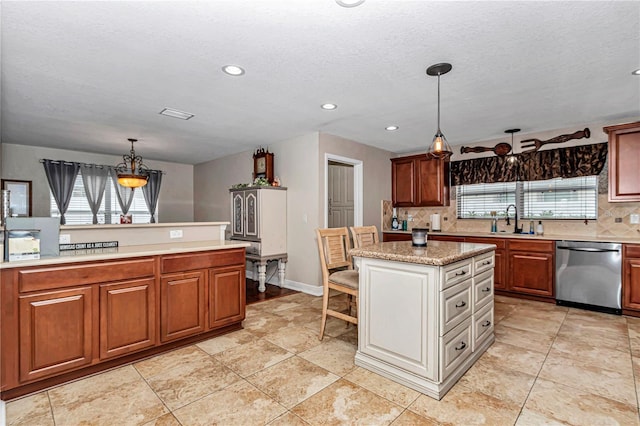 kitchen featuring a sink, a center island, stainless steel dishwasher, brown cabinets, and pendant lighting