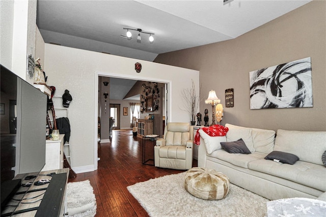 living area featuring lofted ceiling, dark wood-style floors, and baseboards