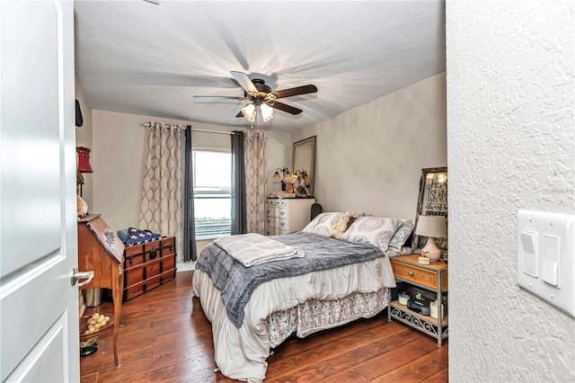 bedroom with ceiling fan and dark wood-style flooring