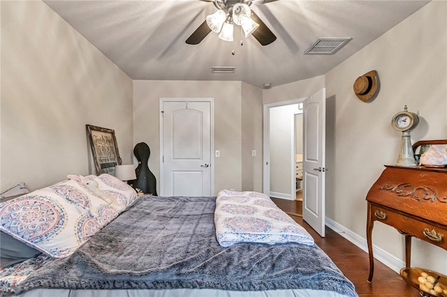 bedroom with baseboards, visible vents, ceiling fan, and dark wood-style flooring