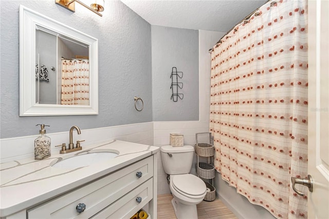 bathroom featuring a textured ceiling, a textured wall, toilet, tile walls, and shower / tub combo with curtain