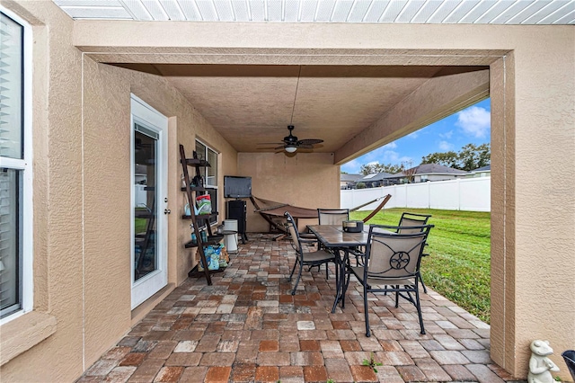 view of patio / terrace with outdoor dining area, fence, and ceiling fan