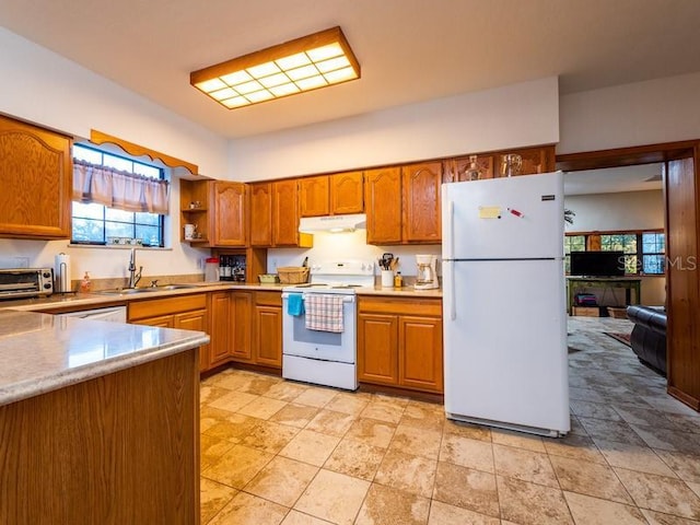 kitchen featuring light countertops, white appliances, and brown cabinetry