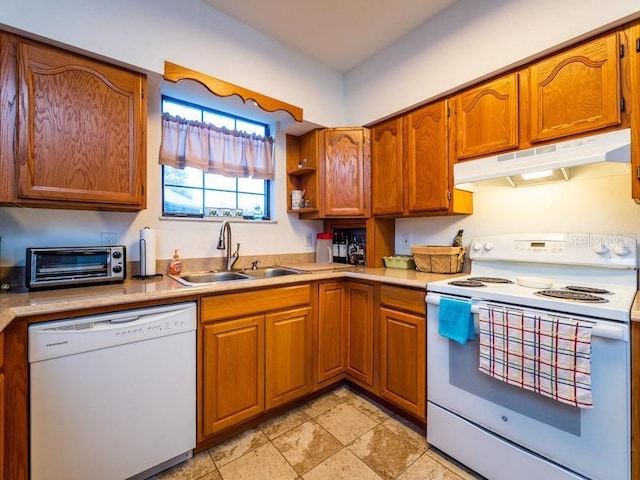 kitchen with brown cabinetry, white appliances, light countertops, and under cabinet range hood