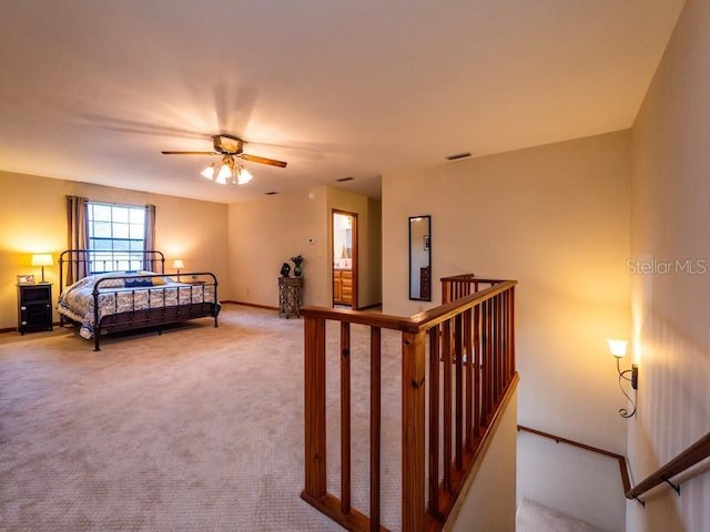 bedroom with carpet floors, visible vents, and baseboards