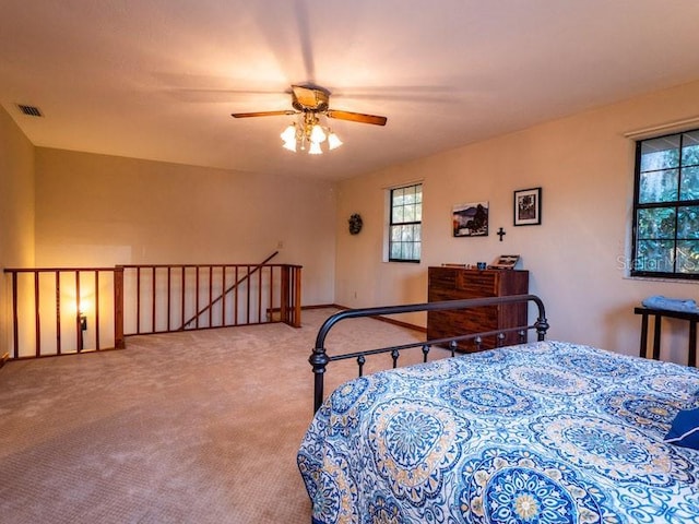 carpeted bedroom with visible vents and ceiling fan