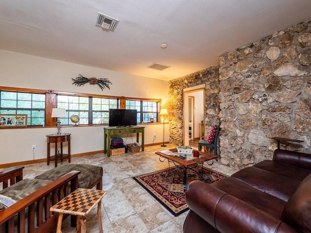 living area featuring visible vents and baseboards