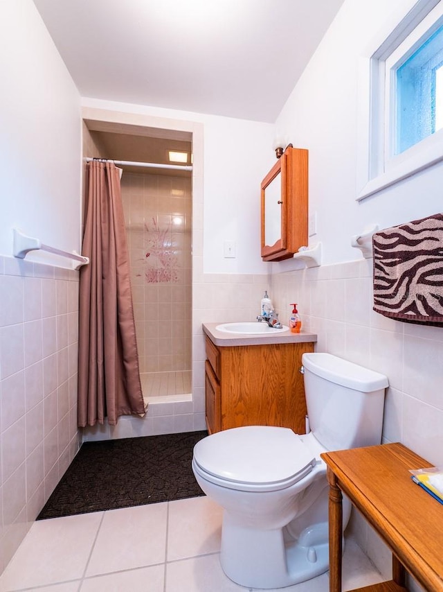 bathroom with tile walls, a shower stall, toilet, and tile patterned floors