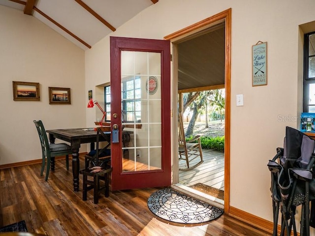 entryway featuring dark wood-type flooring, lofted ceiling, and baseboards