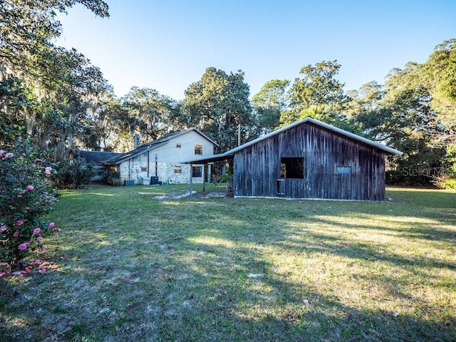 rear view of house featuring a lawn