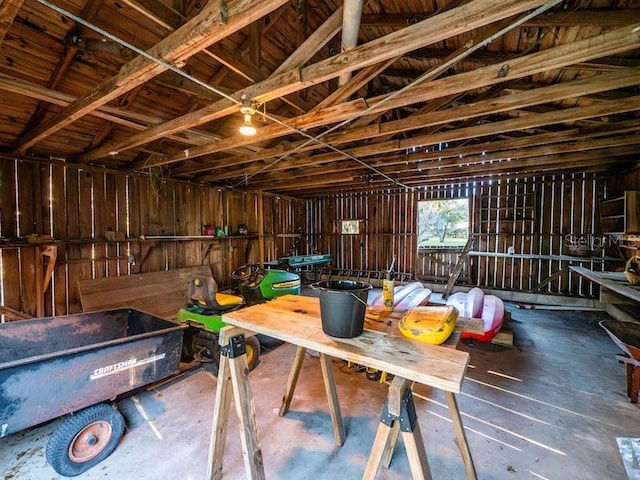 interior space featuring a garage and lofted ceiling