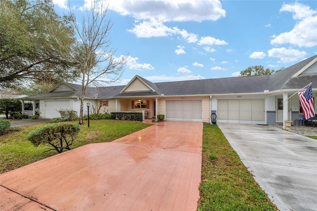 ranch-style house featuring a garage, driveway, and a front lawn