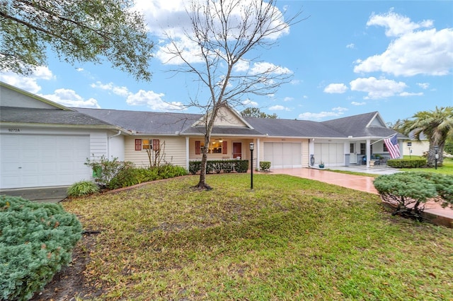 ranch-style house with a garage, driveway, and a front yard