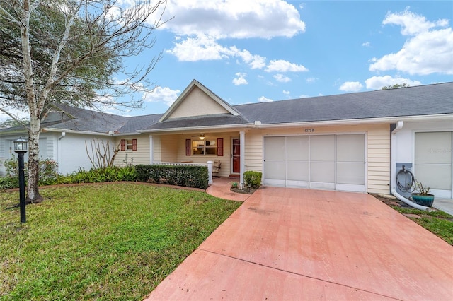 ranch-style home with driveway, an attached garage, and a front lawn