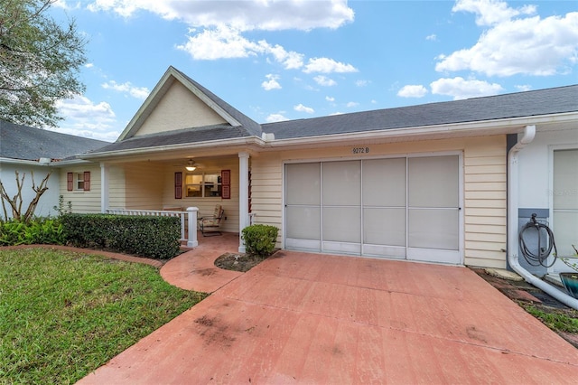 view of front facade with driveway, covered porch, a garage, and a front lawn